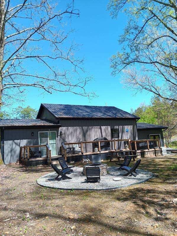 rear view of house featuring a patio area and a deck