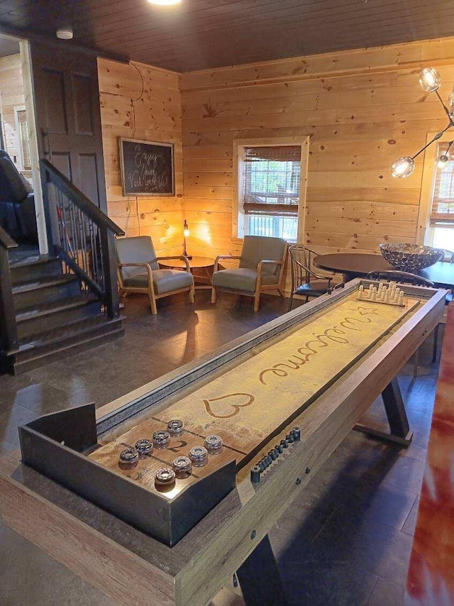 recreation room featuring wood walls