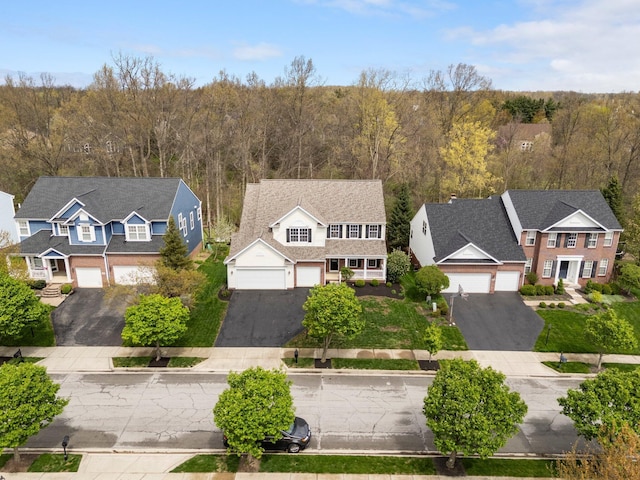 bird's eye view with a wooded view and a residential view