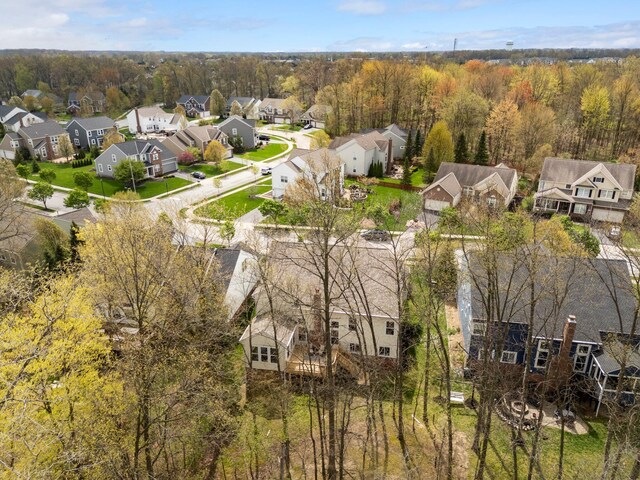 drone / aerial view with a view of trees and a residential view