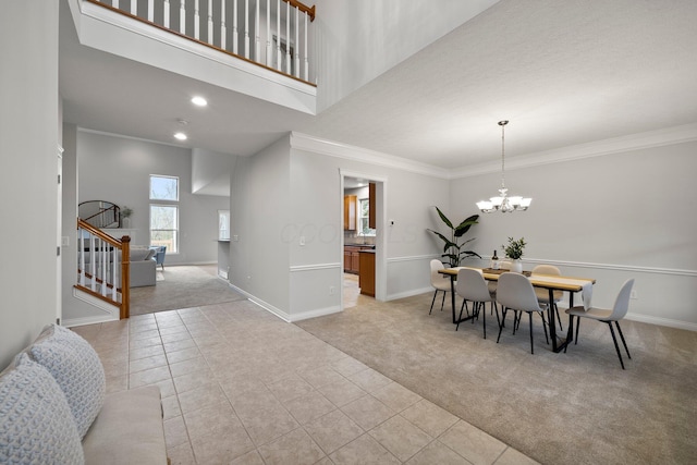 foyer entrance with stairs, light tile patterned flooring, light carpet, baseboards, and ornamental molding