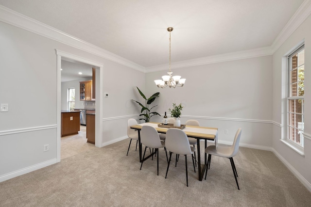 dining space with a notable chandelier, ornamental molding, baseboards, and light carpet