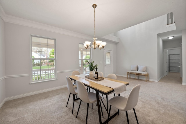 dining space featuring plenty of natural light, baseboards, and a notable chandelier