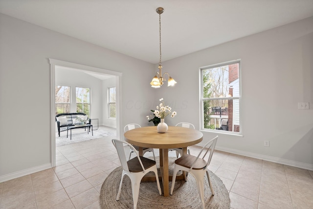 dining room with light tile patterned flooring, a healthy amount of sunlight, and baseboards