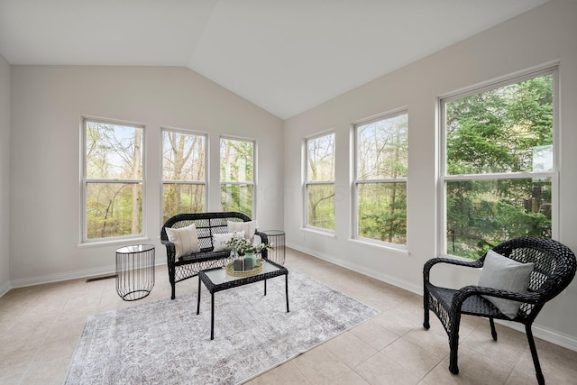 sunroom with tile patterned floors, vaulted ceiling, visible vents, and baseboards