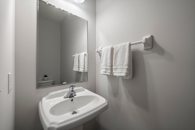 half bathroom featuring a sink