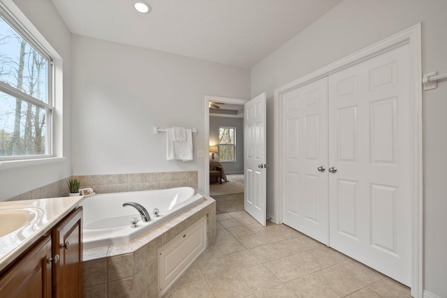 ensuite bathroom with recessed lighting, tile patterned flooring, vanity, ensuite bath, and a garden tub