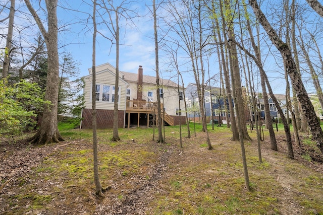 view of yard featuring a wooden deck and stairs