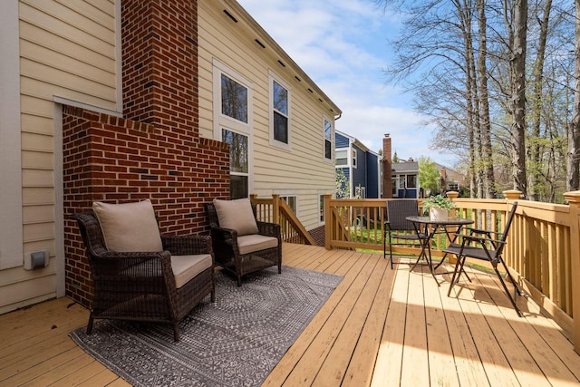 wooden terrace with outdoor dining area and a residential view