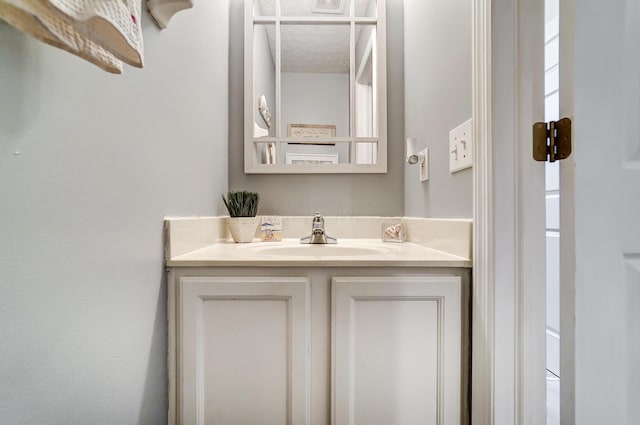 bathroom with a textured ceiling and vanity