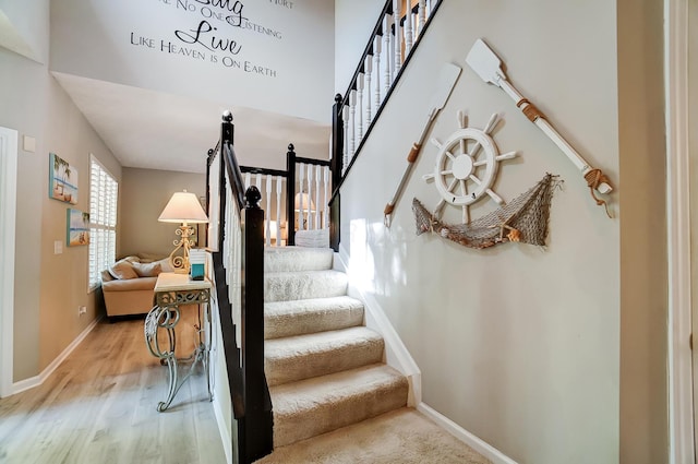 stairway featuring wood finished floors and baseboards