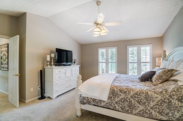 bedroom featuring ceiling fan, light carpet, lofted ceiling, and baseboards