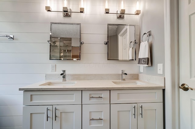 bathroom with wooden walls, a sink, and double vanity