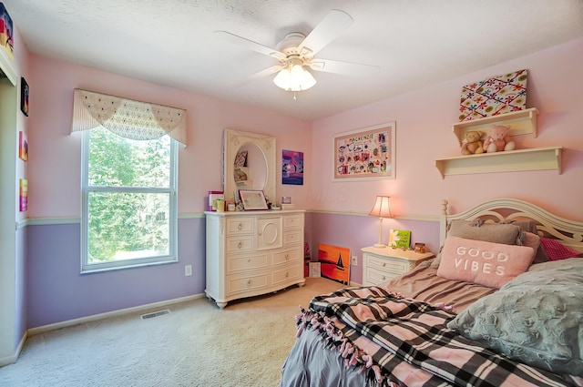 bedroom with ceiling fan, visible vents, baseboards, and light carpet