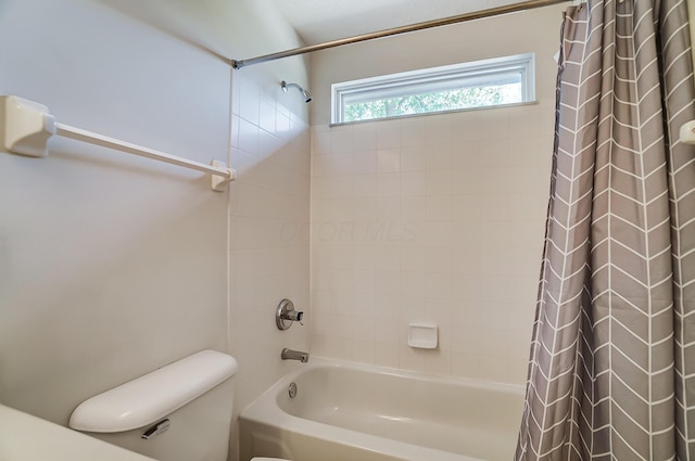 full bathroom featuring toilet and shower / tub combo with curtain