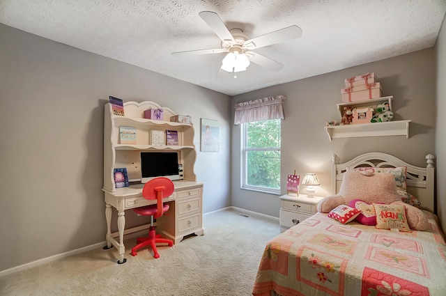 bedroom with light carpet, a ceiling fan, baseboards, and a textured ceiling
