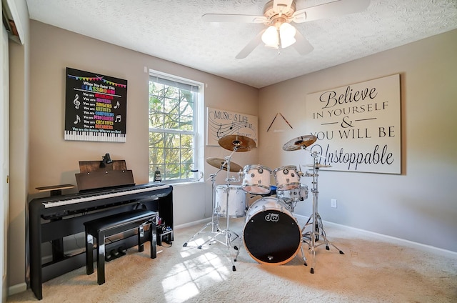 recreation room with plenty of natural light, baseboards, carpet, and a textured ceiling