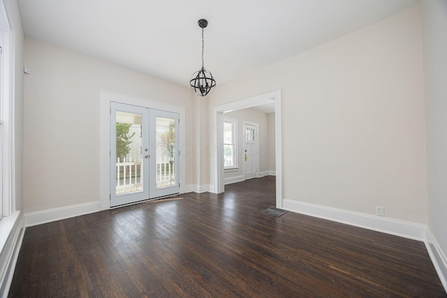 196 E Woodrow Ave, Columbus, OH 43207 - spare room with dark wood-style floors, french doors, baseboards, and a chandelier