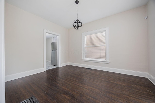 196 E Woodrow Ave, Columbus, OH 43207 - unfurnished dining area with dark wood-style floors, baseboards, and a chandelier