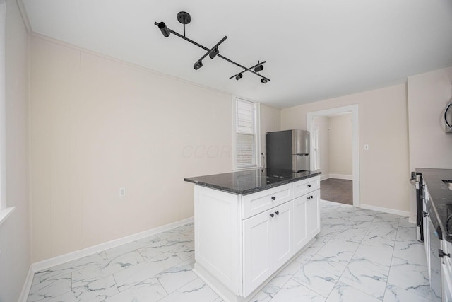 196 E Woodrow Ave, Columbus, OH 43207 - kitchen with freestanding refrigerator, light marble finish flooring, baseboards, and dark stone counters