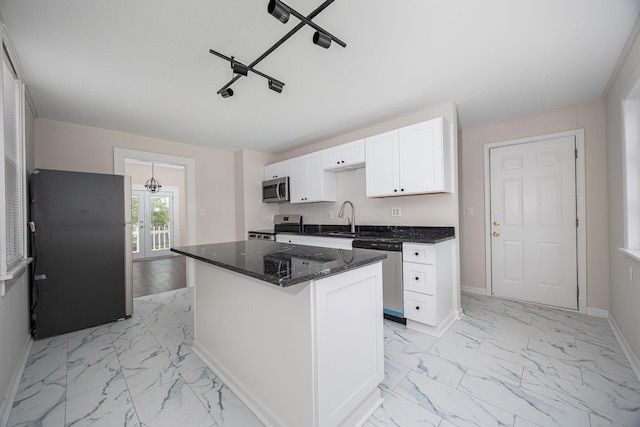 196 E Woodrow Ave, Columbus, OH 43207 - kitchen featuring stainless steel appliances, a sink, light marble finish flooring, white cabinets, and dark stone countertops