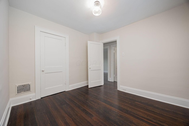 196 E Woodrow Ave, Columbus, OH 43207 - unfurnished bedroom with baseboards and dark wood-type flooring
