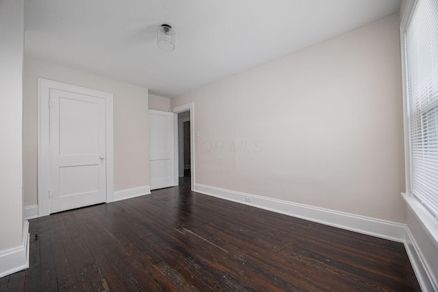 196 E Woodrow Ave, Columbus, OH 43207 - unfurnished bedroom featuring dark wood-style flooring and baseboards