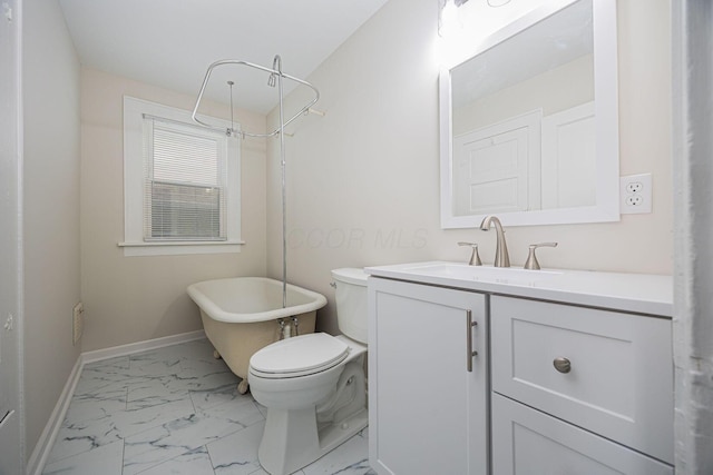 196 E Woodrow Ave, Columbus, OH 43207 - bathroom with a freestanding bath, marble finish floors, vanity, baseboards, and toilet