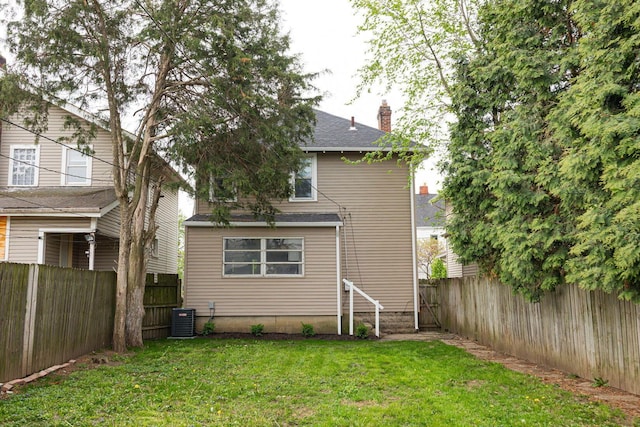 196 E Woodrow Ave, Columbus, OH 43207 - rear view of property with a chimney, central air condition unit, and a shingled roof