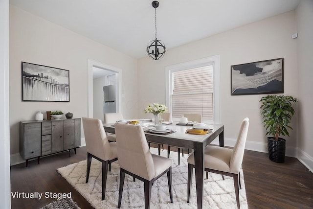 196 E Woodrow Ave, Columbus, OH 43207 - dining room with wood finished floors, baseboards, and a chandelier