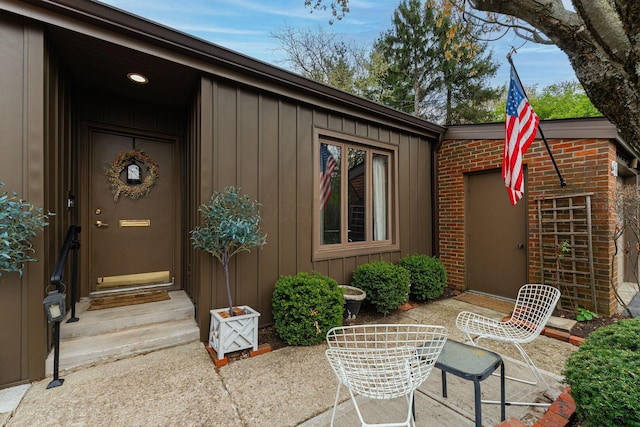 91 Glen Dr, Worthington, OH 43085 - doorway to property with a patio and board and batten siding