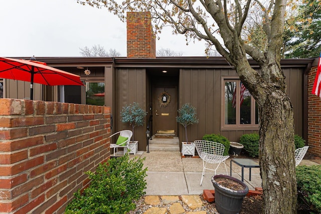 91 Glen Dr, Worthington, OH 43085 - entrance to property featuring board and batten siding and a chimney