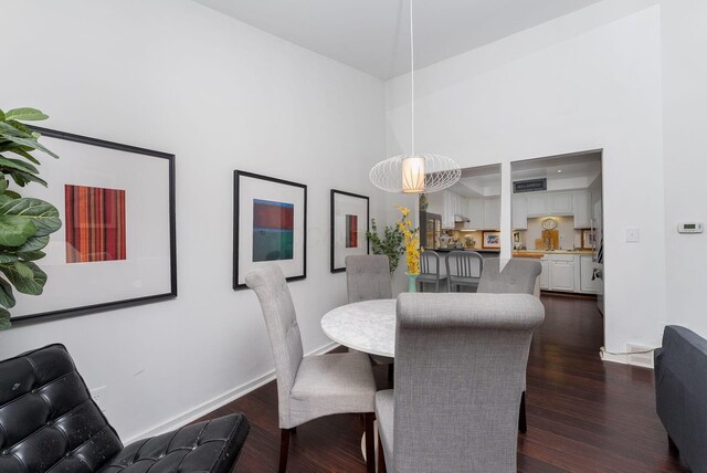 91 Glen Dr, Worthington, OH 43085 - dining room featuring dark wood finished floors, a high ceiling, and baseboards