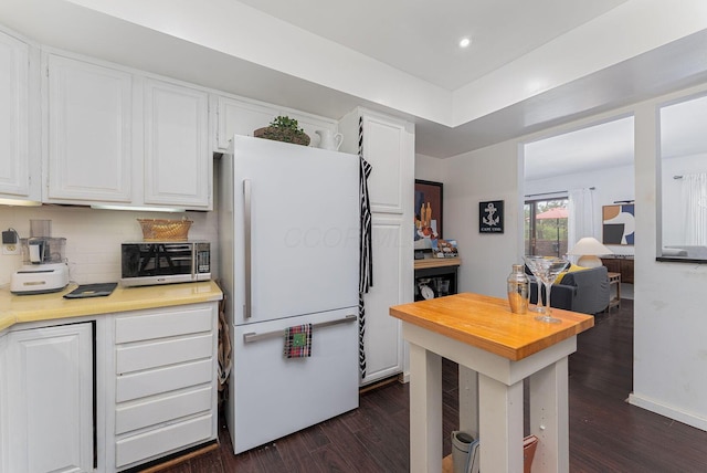 91 Glen Dr, Worthington, OH 43085 - kitchen with white cabinets, wooden counters, freestanding refrigerator, dark wood finished floors, and recessed lighting