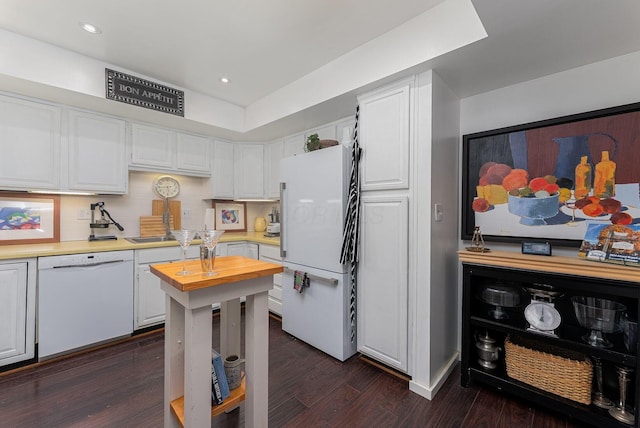 91 Glen Dr, Worthington, OH 43085 - kitchen with dark wood-style flooring, white cabinetry, white appliances, and wooden counters
