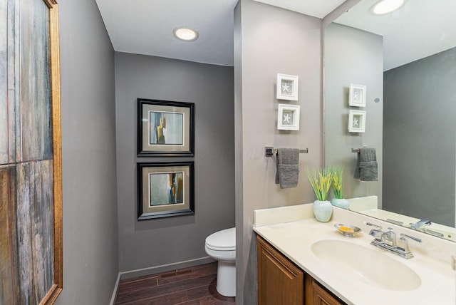 91 Glen Dr, Worthington, OH 43085 - bathroom with baseboards, wood finished floors, toilet, and vanity