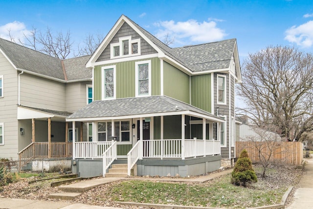 103 W Park Ave, Columbus, OH 43222 - victorian-style house with board and batten siding, roof with shingles, covered porch, and fence
