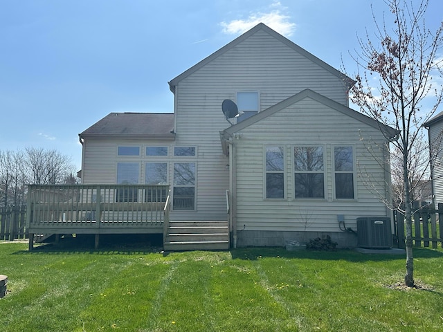 rear view of property featuring a deck, fence, central AC, and a yard