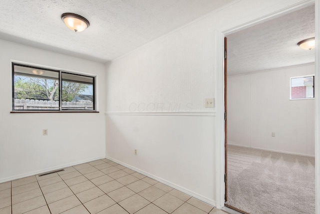 6350 Roselawn Ave, Reynoldsburg, OH 43068 - empty room featuring a healthy amount of sunlight, a textured ceiling, and visible vents