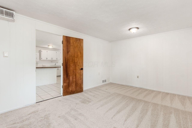 6350 Roselawn Ave, Reynoldsburg, OH 43068 - spare room with a textured ceiling, visible vents, and light colored carpet