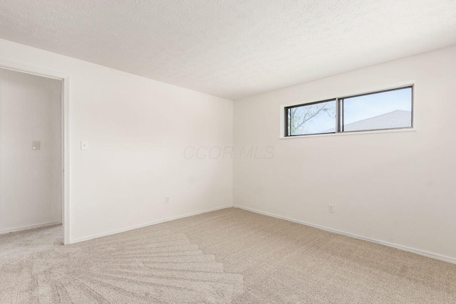 6350 Roselawn Ave, Reynoldsburg, OH 43068 - spare room with baseboards, a textured ceiling, and carpet