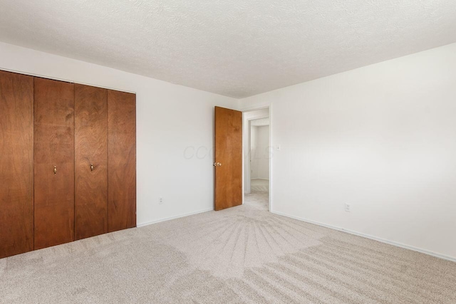 6350 Roselawn Ave, Reynoldsburg, OH 43068 - unfurnished bedroom with a textured ceiling, carpet floors, a closet, and baseboards