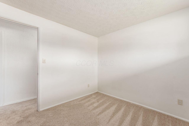 6350 Roselawn Ave, Reynoldsburg, OH 43068 - spare room with light carpet, a textured ceiling, and baseboards
