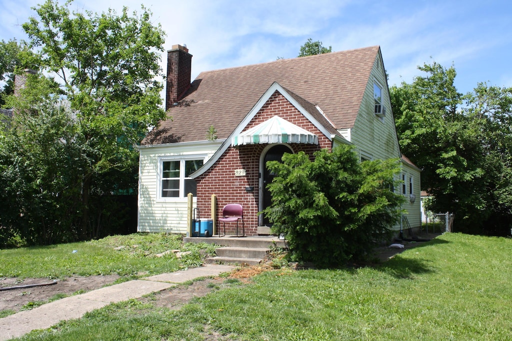929 Bulen Ave, Columbus, OH 43206 - tudor house with a front lawn, a chimney, and roof with shingles
