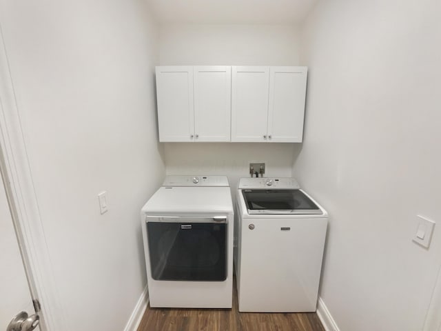 laundry area featuring cabinet space, dark wood-type flooring, baseboards, and washer and dryer