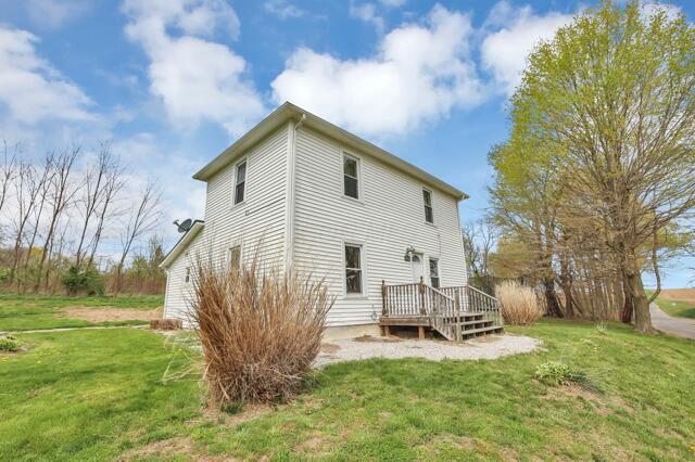 rear view of property with a lawn