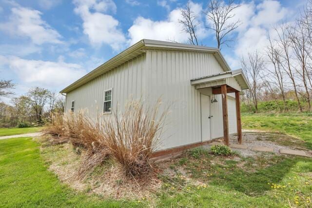view of side of home with a lawn