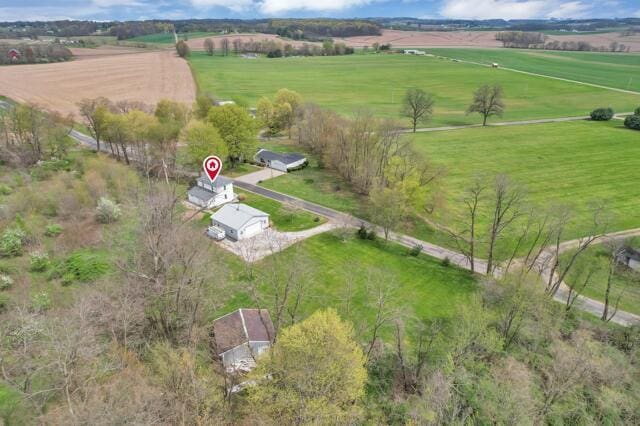 birds eye view of property with a rural view