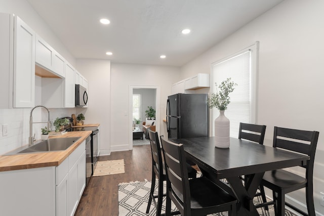 238 E Barthman Ave, Columbus, OH 43207 - dining room featuring recessed lighting, baseboards, and dark wood-type flooring