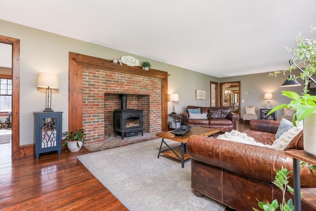 living room with wood finished floors and a wood stove